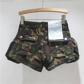 Camouflage shorts on a wooden hanger against a white background